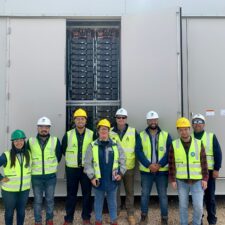 Group of Chilean engineers pose for a photo in-front of a battery storage Vistra’s Moss Landing Energy Storage Facility